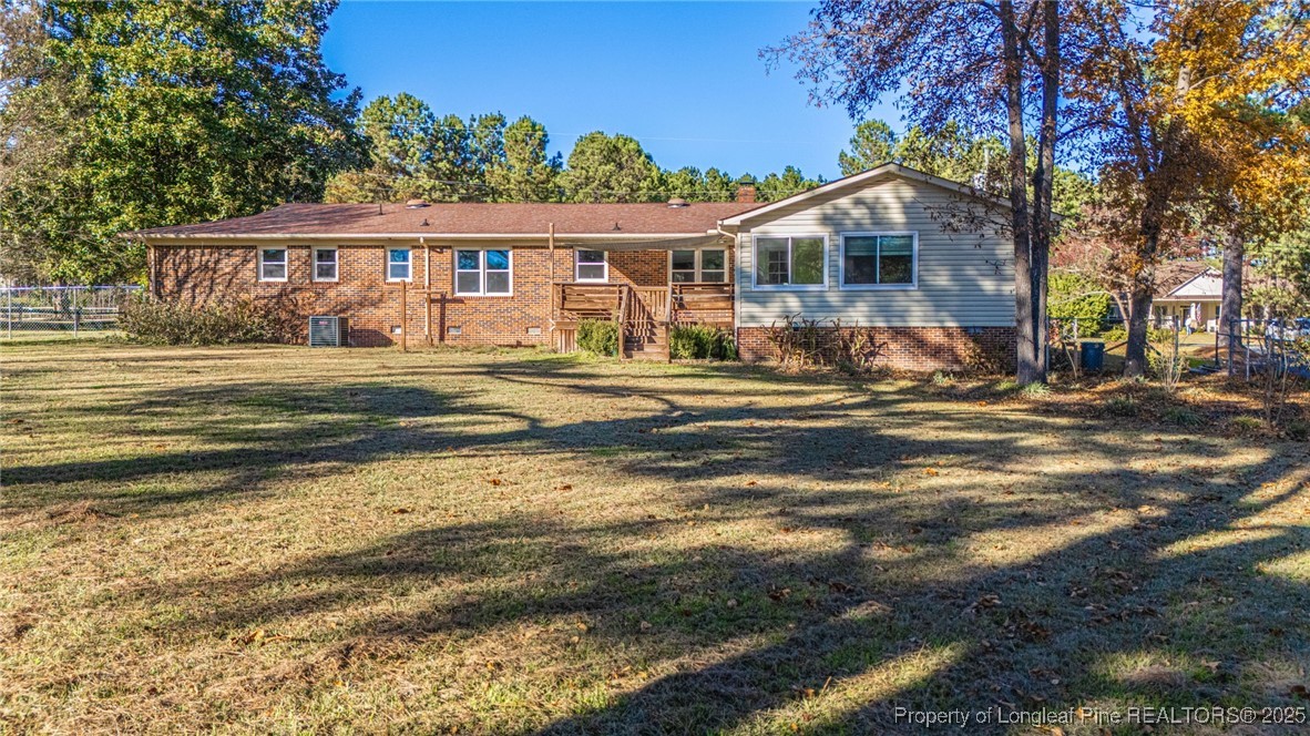 255 Foxcroft Road Whispering Pines, NC 28327 - Photo 29 of 31 a front view of a house with a garden