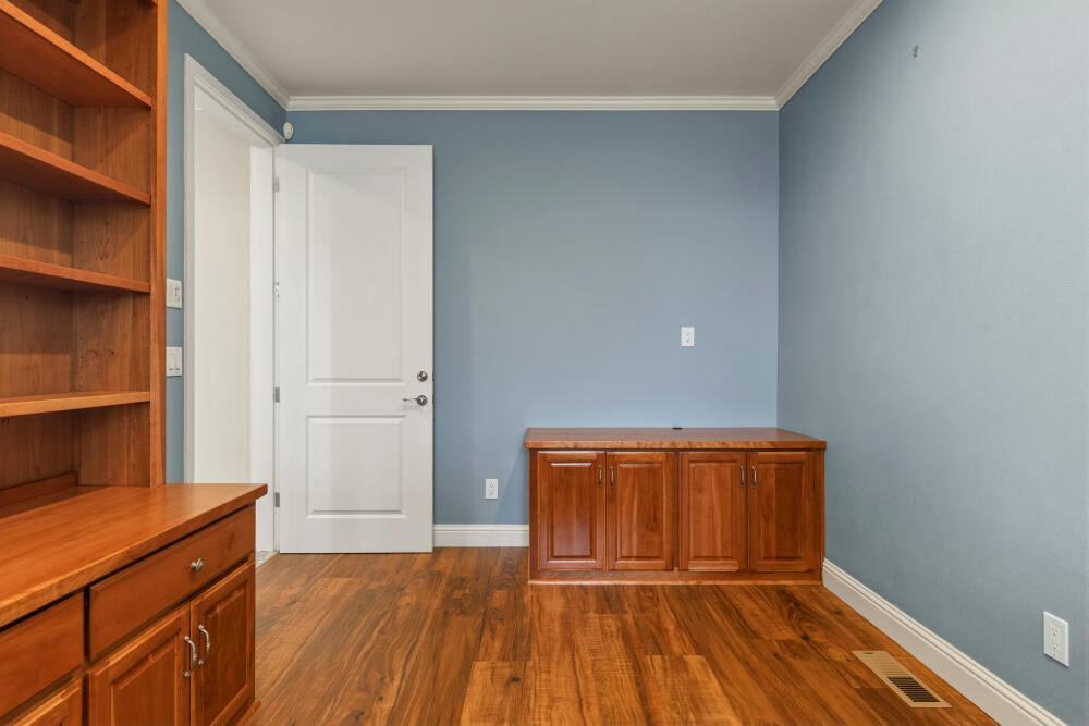 6586 Cooper's Hawk Road Klamath Falls, OR 97601 - Photo 52 of 68 a view of empty room with wooden floor and cabinet