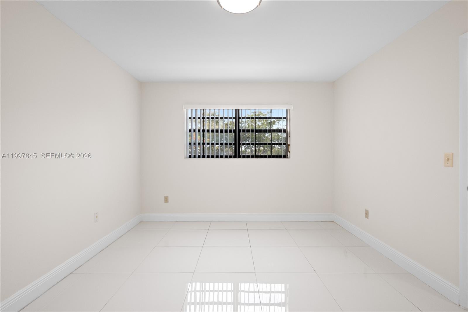 6211 Southwest 138th Court, Unit B Miami, FL 33183 - Photo 21 of 27 an empty room with a window