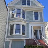 a front view of a house with yard and garage