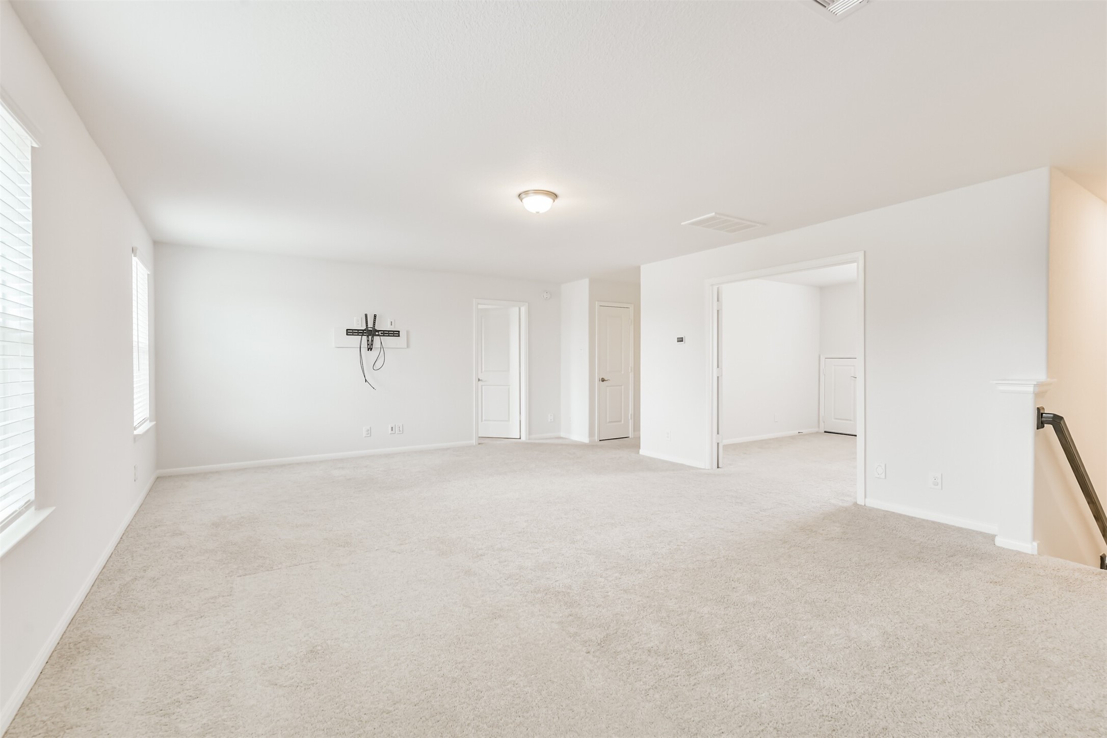 2129 Solstice Boulevard Spring, TX 77386 - Photo 37 of 49 Game Room:
Spacious upstairs game room perfect for a second living area, play space, or media room. Bright with natural light, neutral tones, and plenty of room for large furniture or entertainment setups. Opens directly to the adjoining flex/bedroom for added versatility.