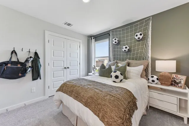 a bedroom with a bed and a dresser