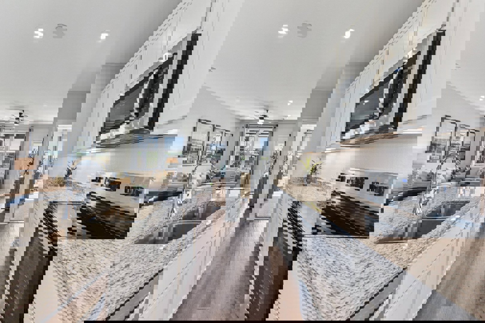 10601 Justify Lane Buda, TX 78610 - Photo 3 of 20 a kitchen with stainless steel appliances granite countertop a sink a stove oven and granite counter tops