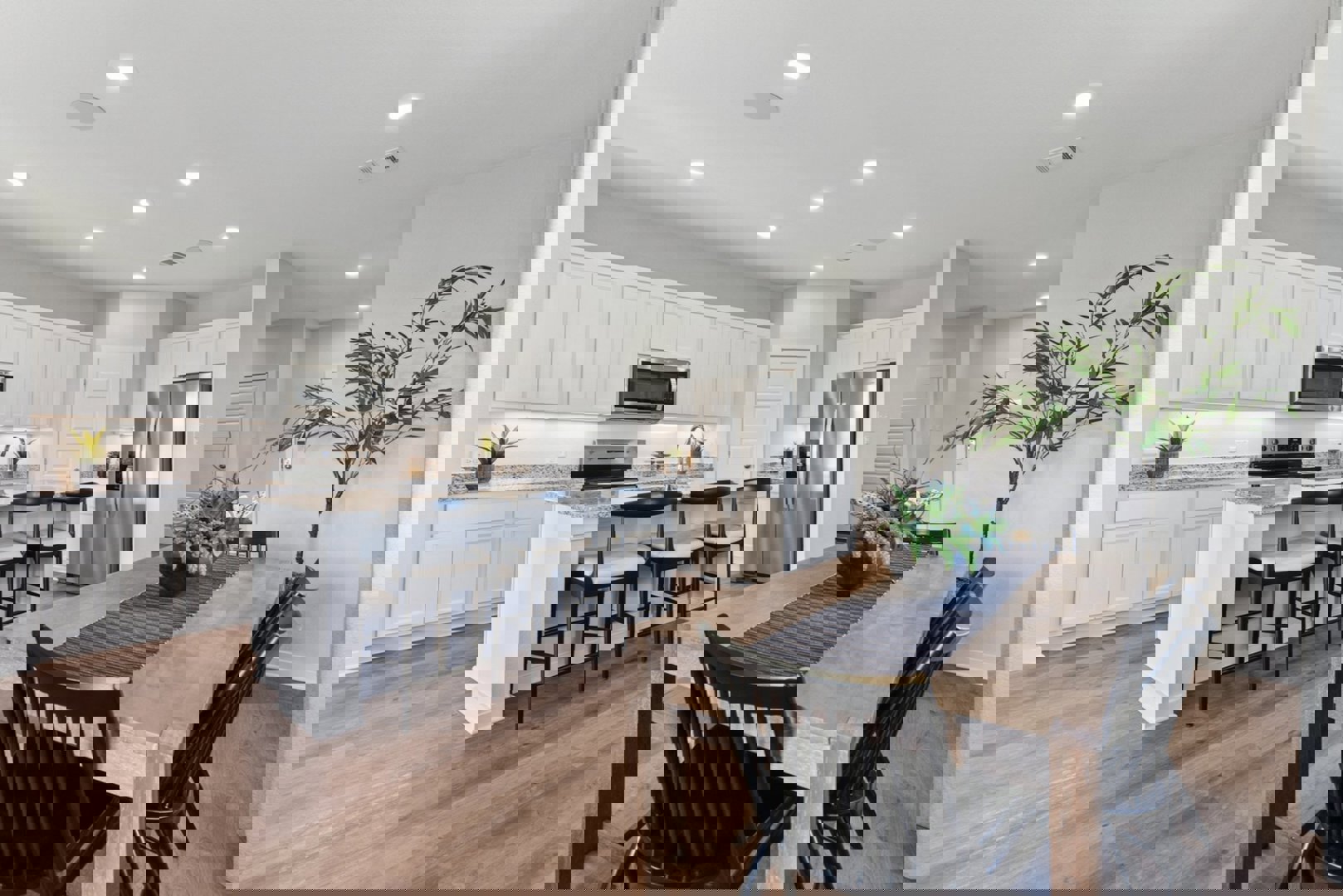 10601 Justify Lane Buda, TX 78610 - Photo 4 of 20 a kitchen with granite countertop white cabinets and stainless steel appliances