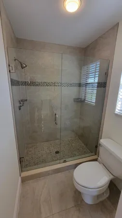 a bathroom with a toilet and a shower