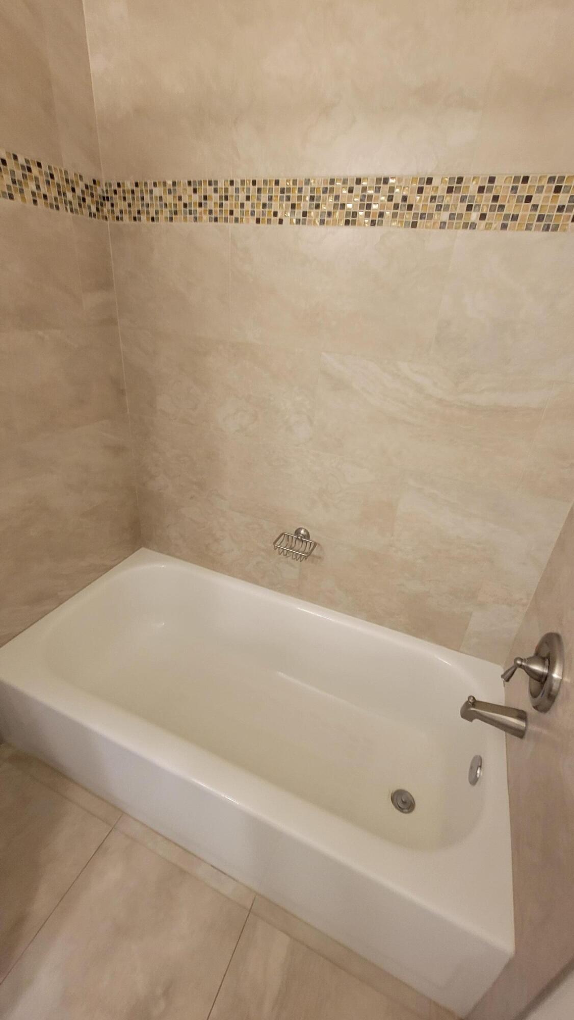 1072 Keystone Drive, Unit A Jupiter, FL 33458 - Photo 21 of 29 a bathroom with a shower and a bath tub