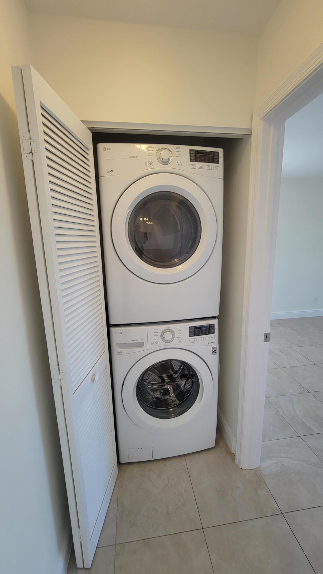 1072 Keystone Drive, Unit A Jupiter, FL 33458 - Photo 22 of 29 a utility room with dryer and washer