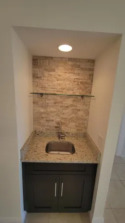 a bathroom with a granite countertop sink