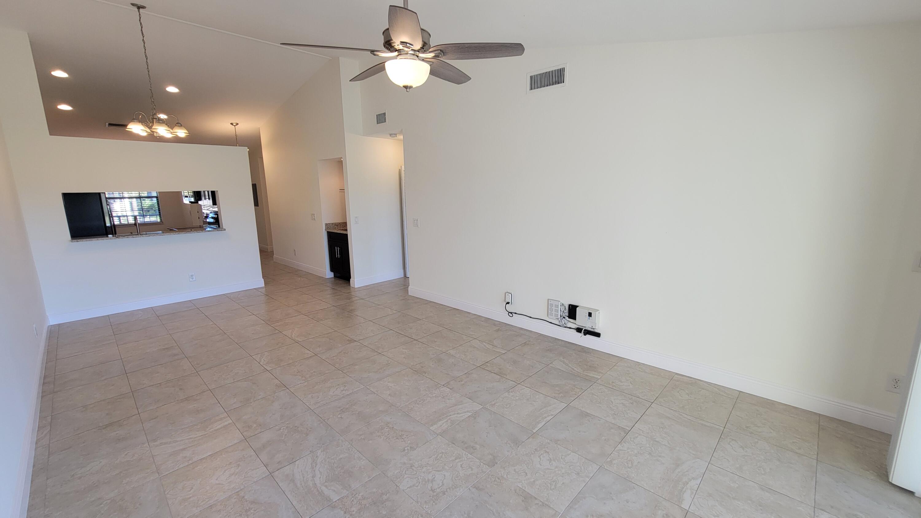 1072 Keystone Drive, Unit A Jupiter, FL 33458 - Photo 10 of 29 an empty room with a ceiling fan and a window
