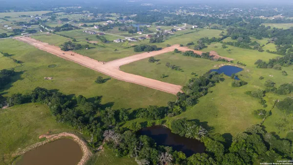 an aerial view of a house with a yard