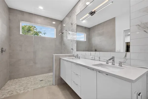 a bathroom with a sink double vanity and a mirror
