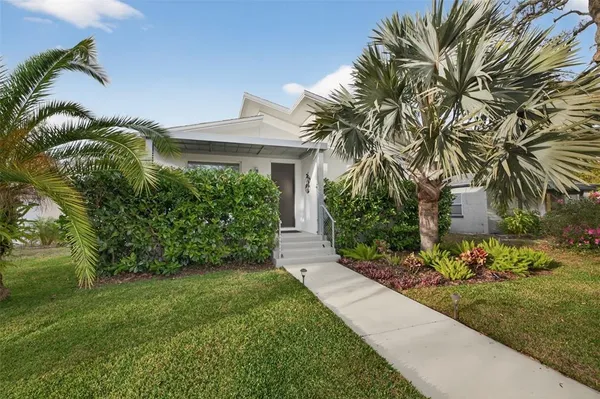 a front view of a house with a garden