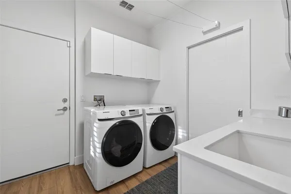a utility room with sink dryer and washer