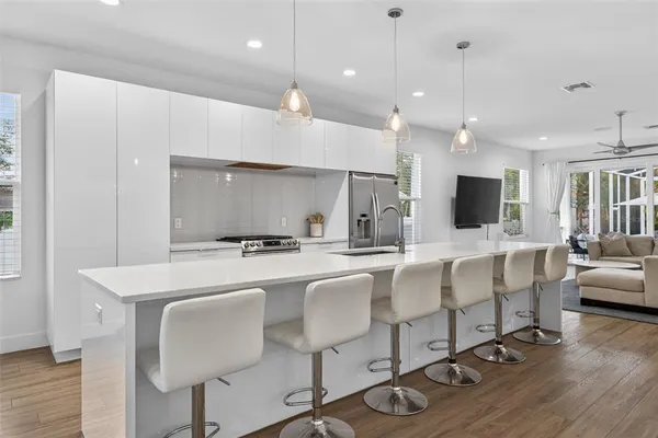 a large kitchen with a table and chairs