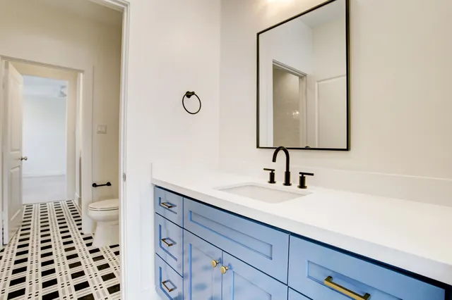 a bathroom with a sink a vanity and a mirror