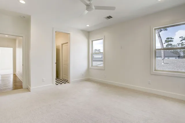 an empty room with windows and closet
