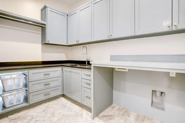 a kitchen with granite countertop white cabinets and white appliances