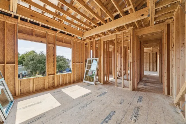 an empty room with large windows
