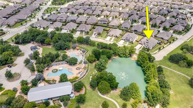 an aerial view of house with yard swimming pool and outdoor seating