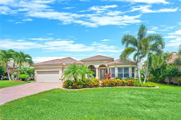 a view of a house with a big yard plants and large trees