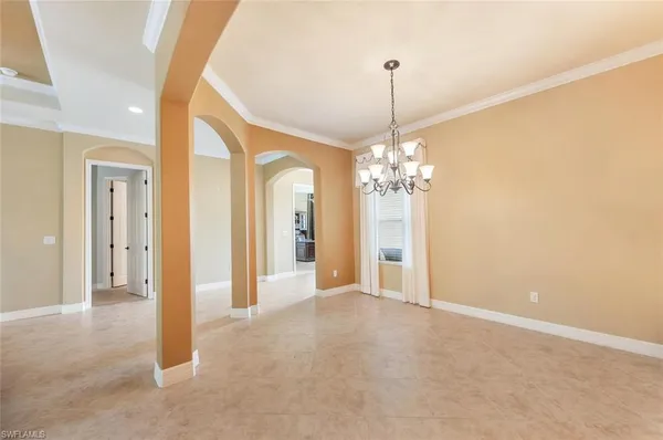 a view of a chandelier in big room and a bathroom