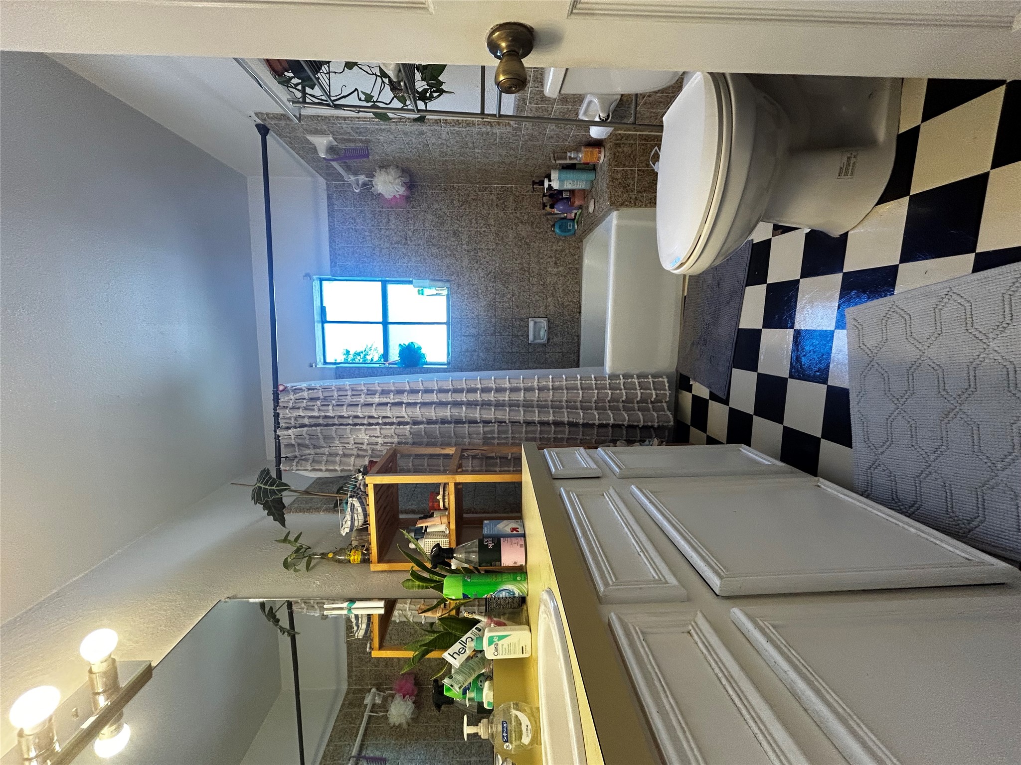 4511 B Avenue, Unit B Austin, TX 78751 - Photo 22 of 30 a bathroom with a sink a toilet and shower