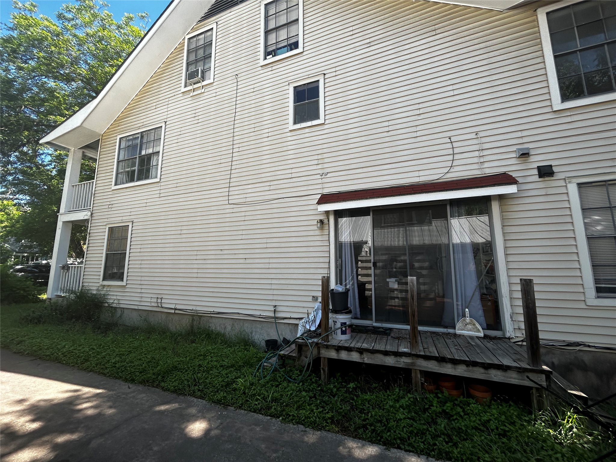 4511 B Avenue, Unit B Austin, TX 78751 - Photo 26 of 30 a view of a white house with a small yard and a large window