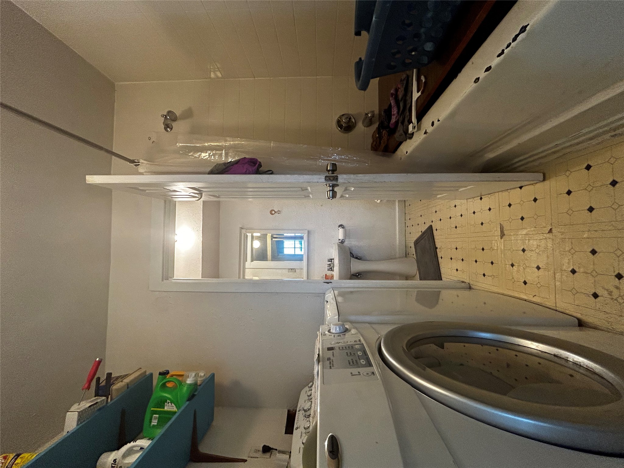 4511 B Avenue, Unit B Austin, TX 78751 - Photo 4 of 30 a bathroom with a sink a washer and dryer