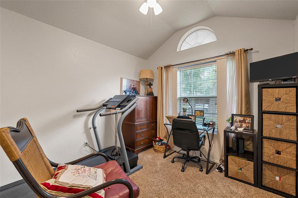 4617 Lexington Street Waco, TX 76705 - Photo 4 of 14 Vaulted ceiling with an arched transom window, paired with a standard window featuring blinds and drapes