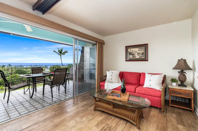 a living room with furniture a rug and a table