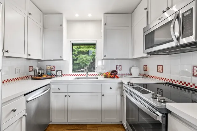 a kitchen with a white cabinets and white appliances