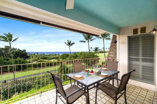 a view of a balcony with two chairs and a table