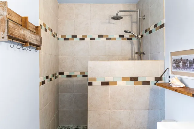 a view of a bathroom with bathtub and shower