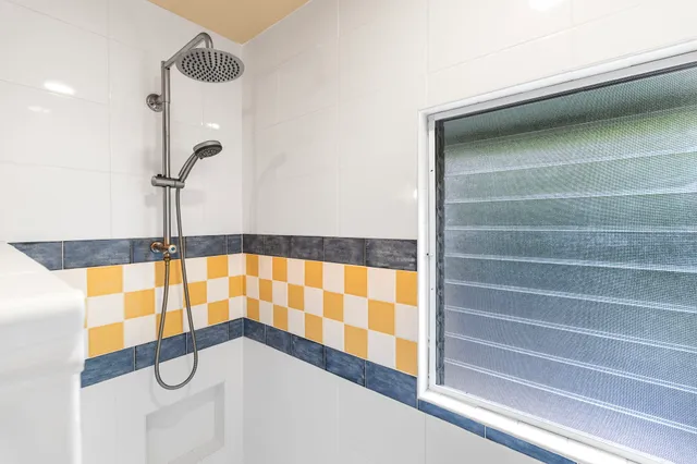 a bathroom with a shower and a sink