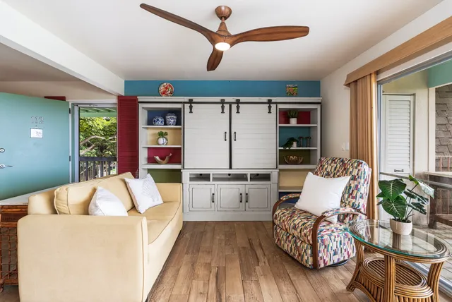 a living room with furniture and wooden floor