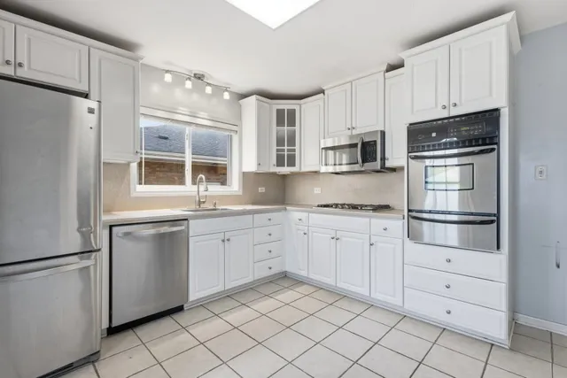 a kitchen with granite countertop cabinets and steel stainless steel appliances