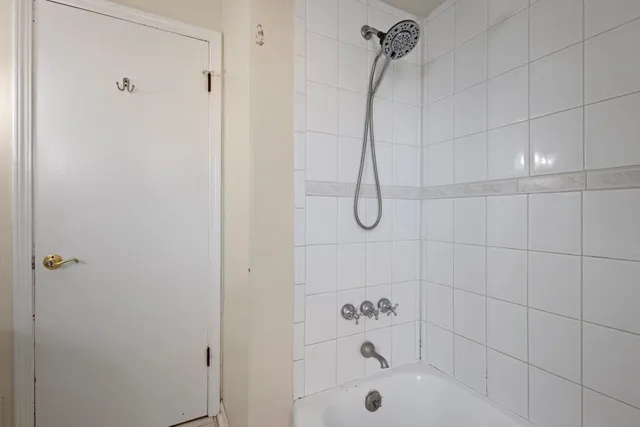a bathroom with a bath tub with a shower
