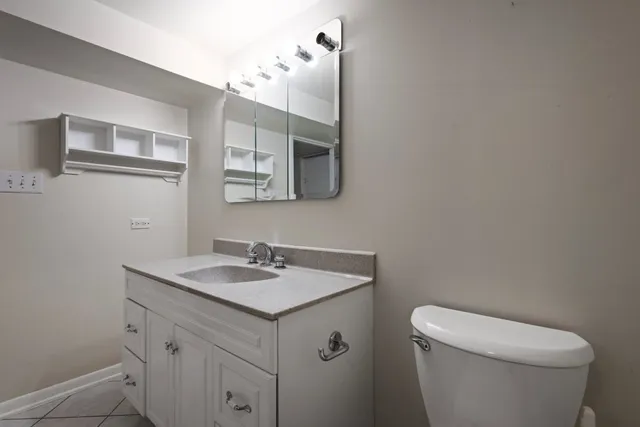 a bathroom with a granite countertop shower and a toilet