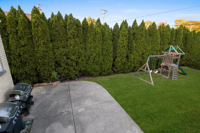 a view of a backyard with sitting area