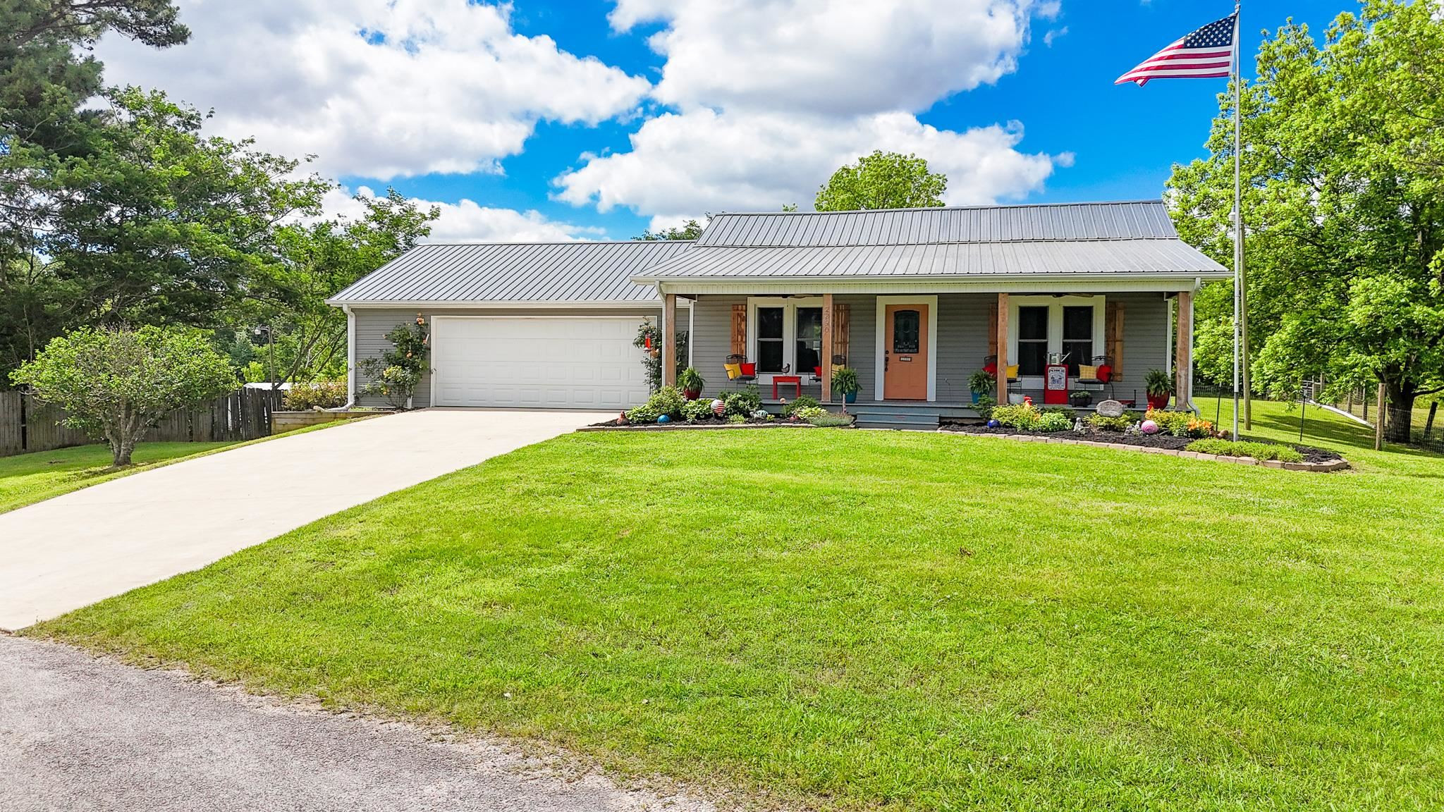 2390 Dr Lewis Road Ripley, TN 38063 - Photo 1 of 48 a front view of a house with a garden and trees