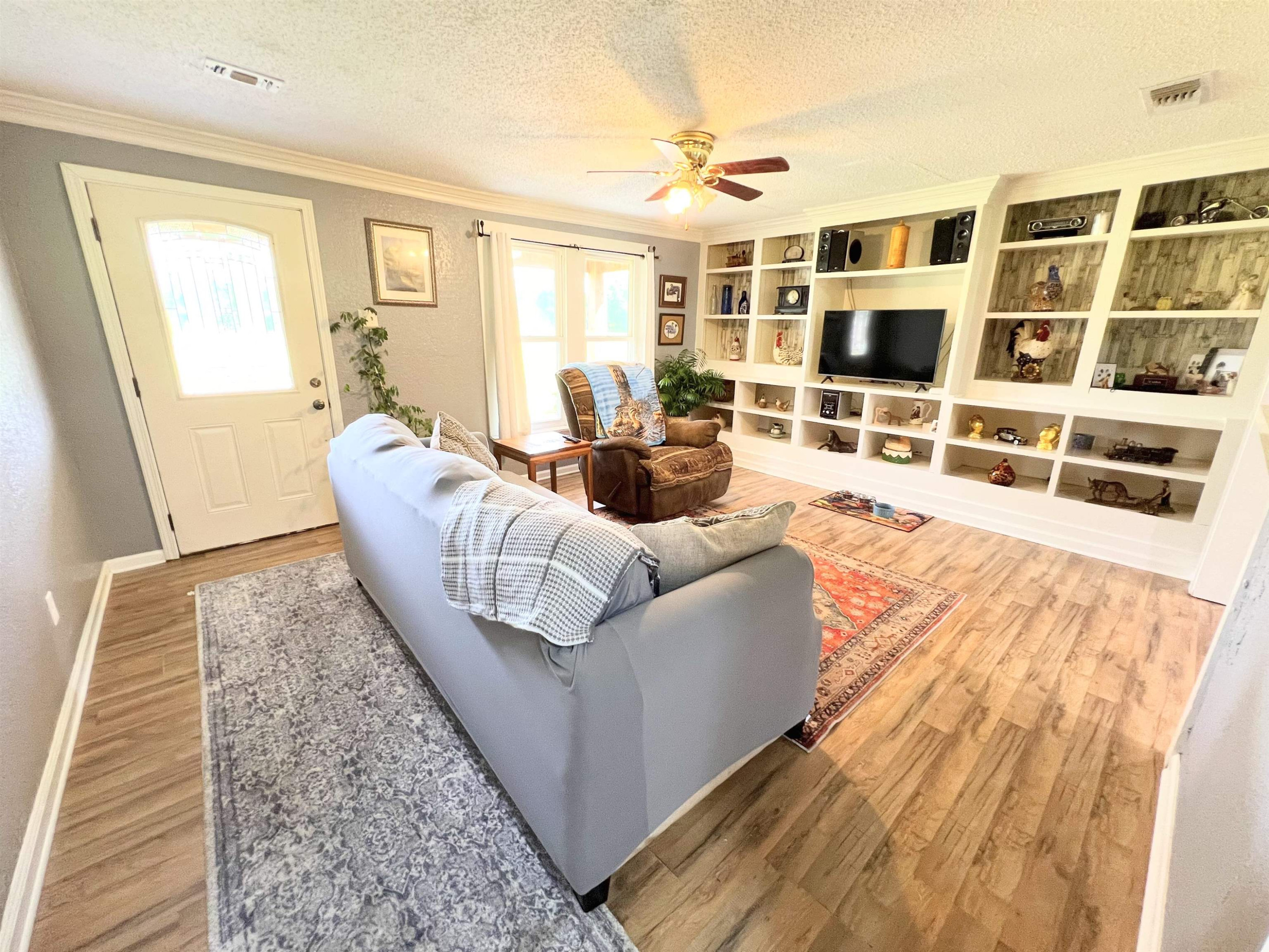 2390 Dr Lewis Road Ripley, TN 38063 - Photo 17 of 48 a living room with furniture windows and wooden floor