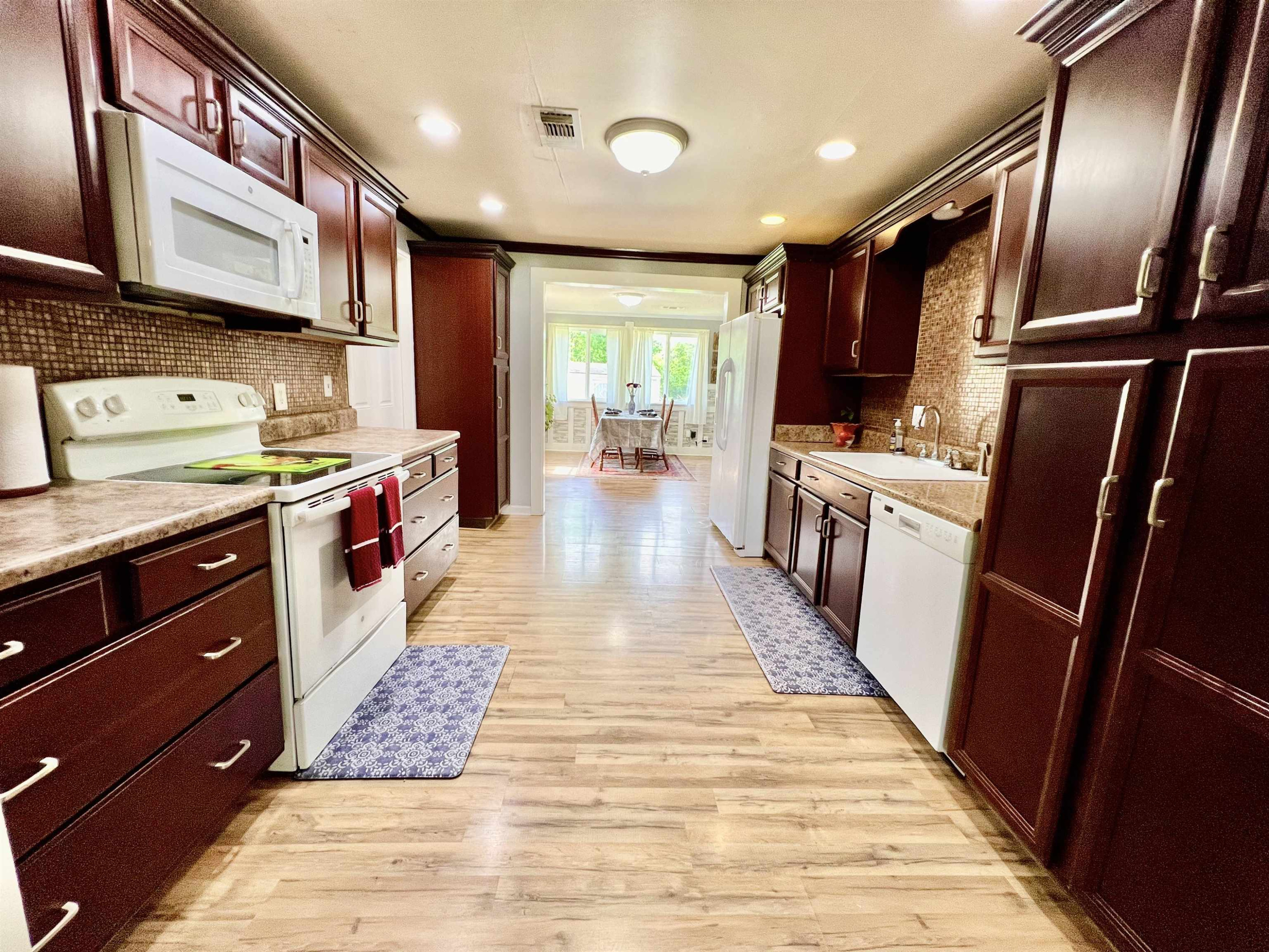 2390 Dr Lewis Road Ripley, TN 38063 - Photo 19 of 48 a kitchen with stainless steel appliances granite countertop a sink stove and refrigerator