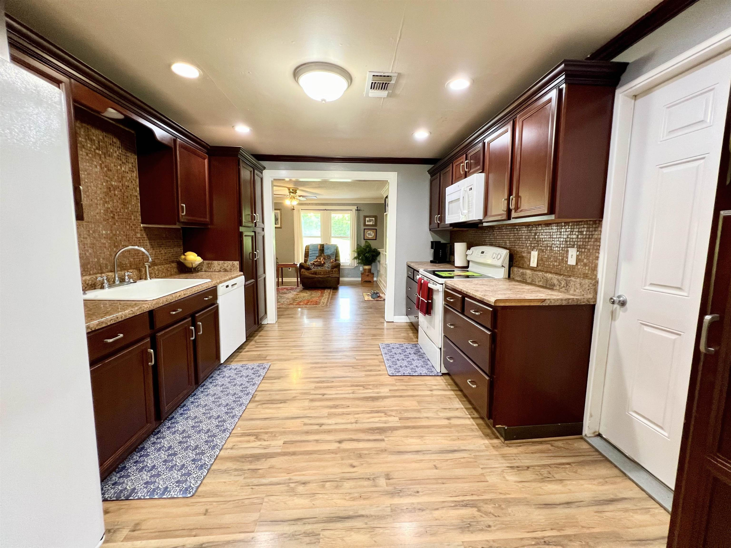 2390 Dr Lewis Road Ripley, TN 38063 - Photo 20 of 48 a large kitchen with stainless steel appliances kitchen island granite countertop a large counter top a sink a stove and cabinets