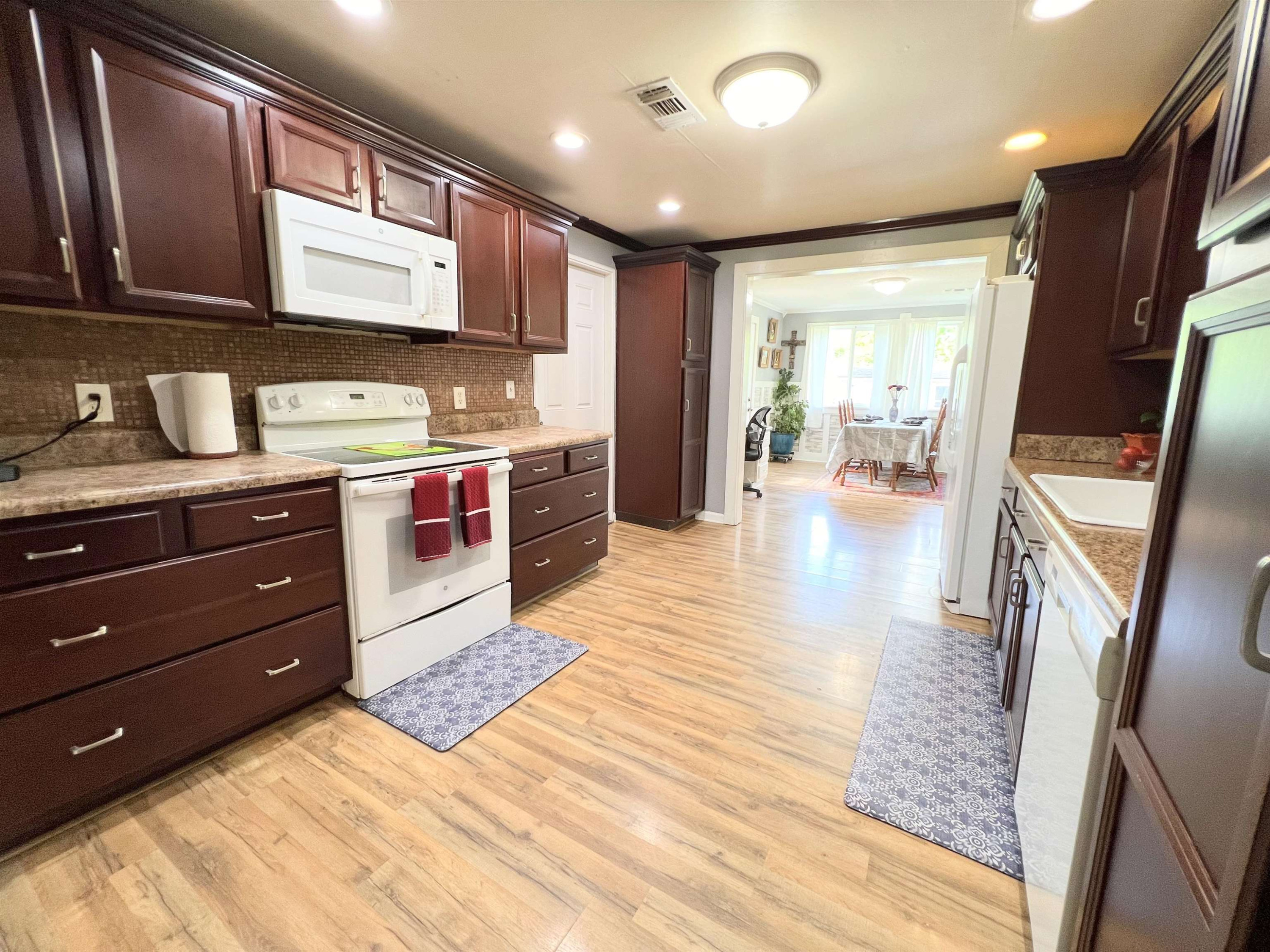 2390 Dr Lewis Road Ripley, TN 38063 - Photo 23 of 48 a kitchen with stainless steel appliances granite countertop wooden cabinets a stove top oven a sink and dishwasher