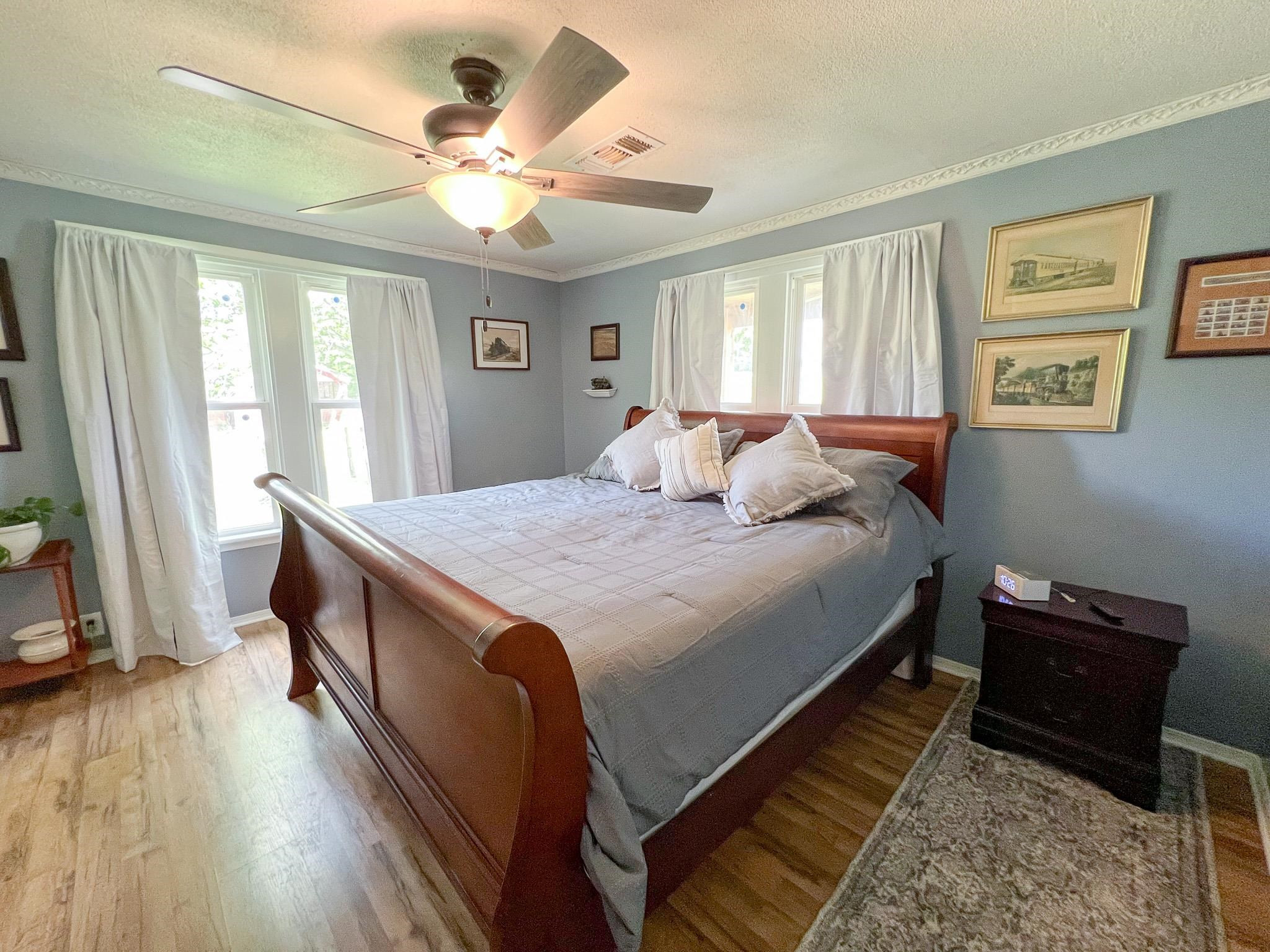 2390 Dr Lewis Road Ripley, TN 38063 - Photo 31 of 48 a bedroom with a bed and a chandelier