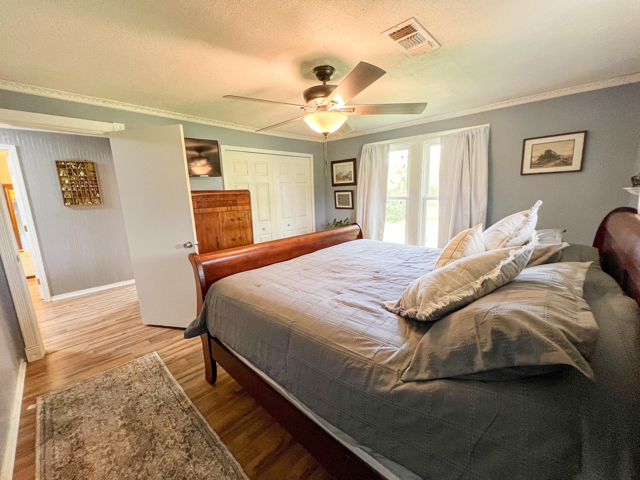 2390 Dr Lewis Road Ripley, TN 38063 - Photo 32 of 48 a bedroom with a large bed and a chandelier