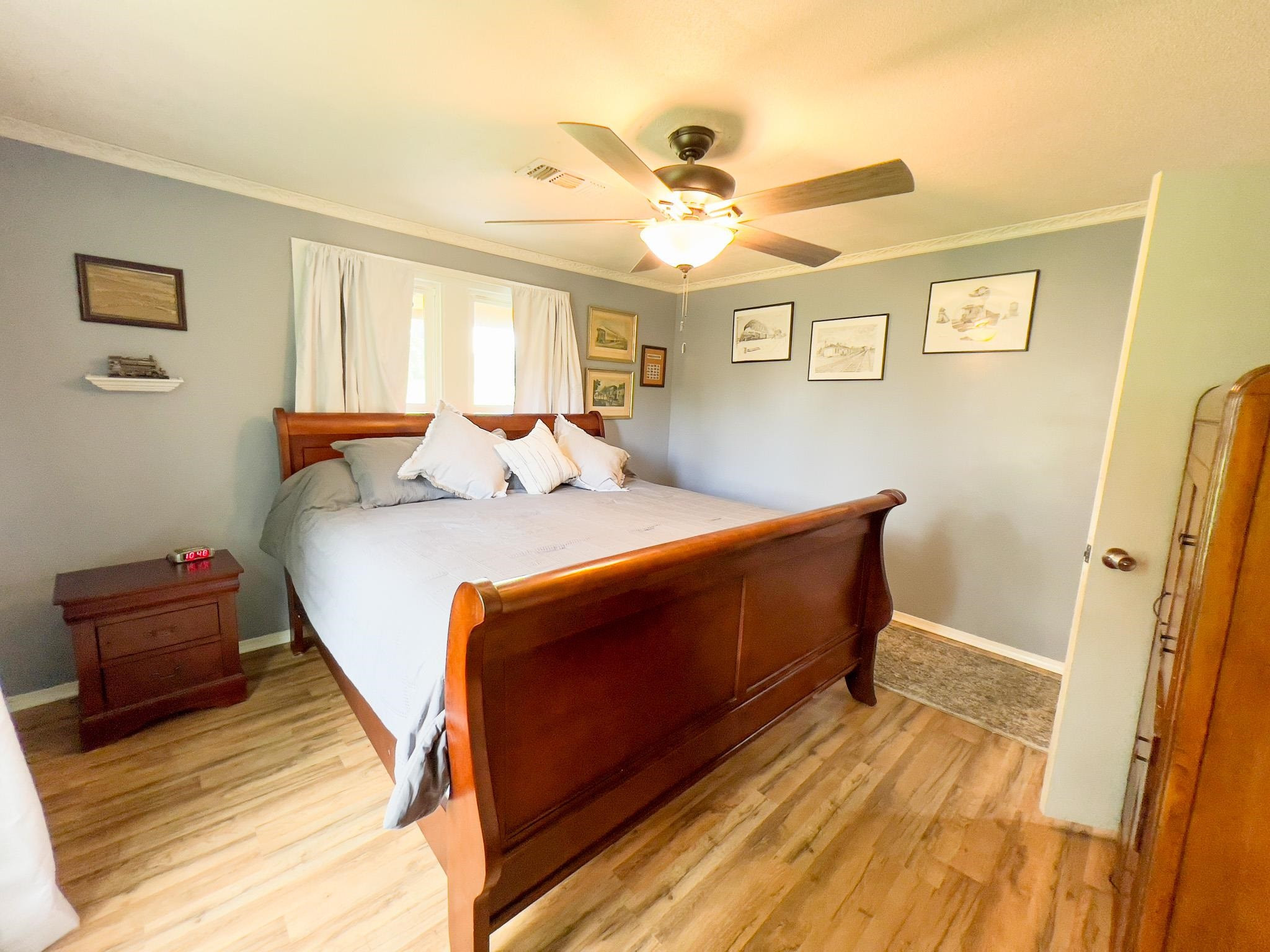 2390 Dr Lewis Road Ripley, TN 38063 - Photo 33 of 48 a bedroom with a bed and wooden floor