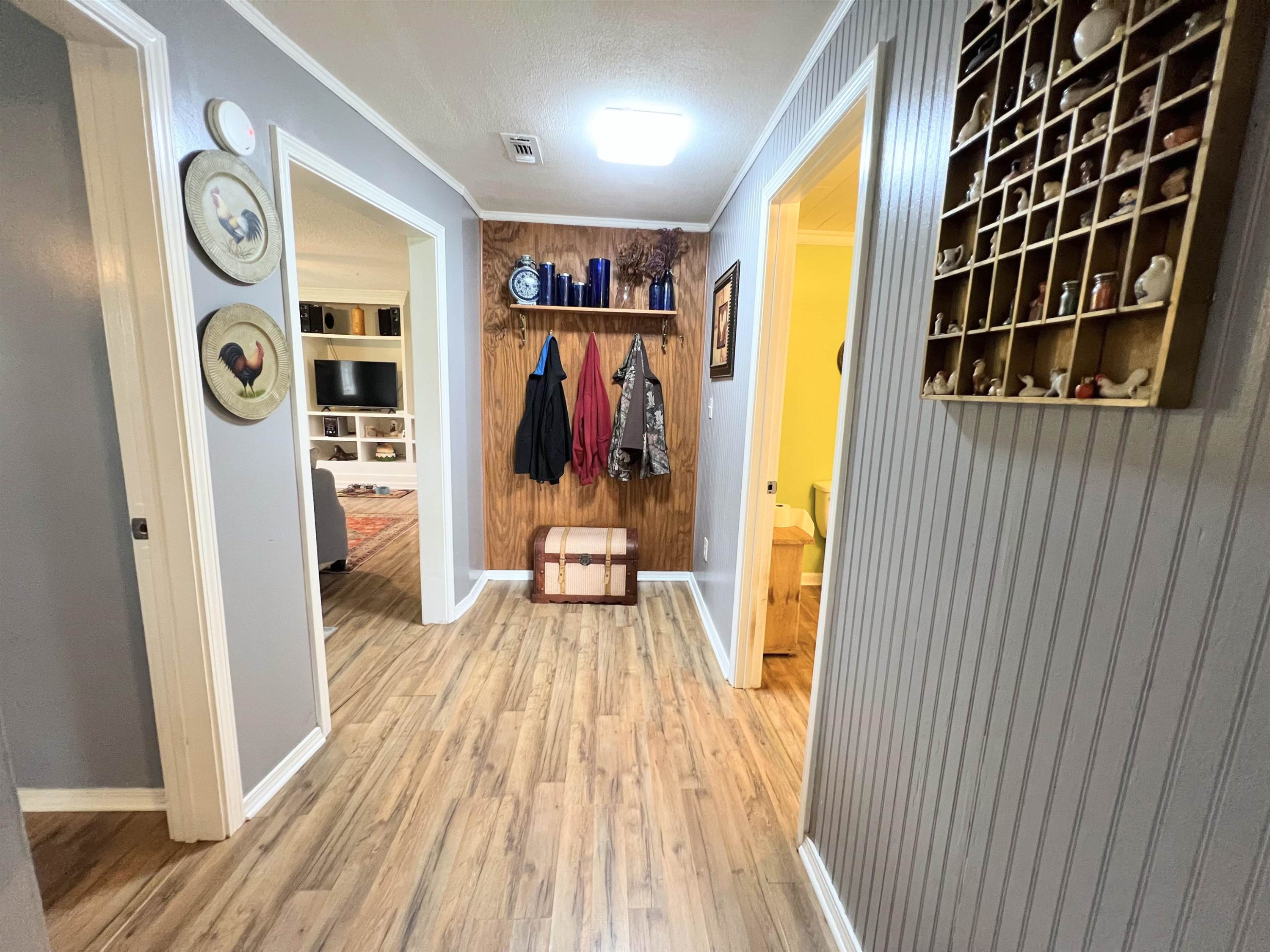 2390 Dr Lewis Road Ripley, TN 38063 - Photo 34 of 48 a view of a hallway with wooden floor and a bathroom