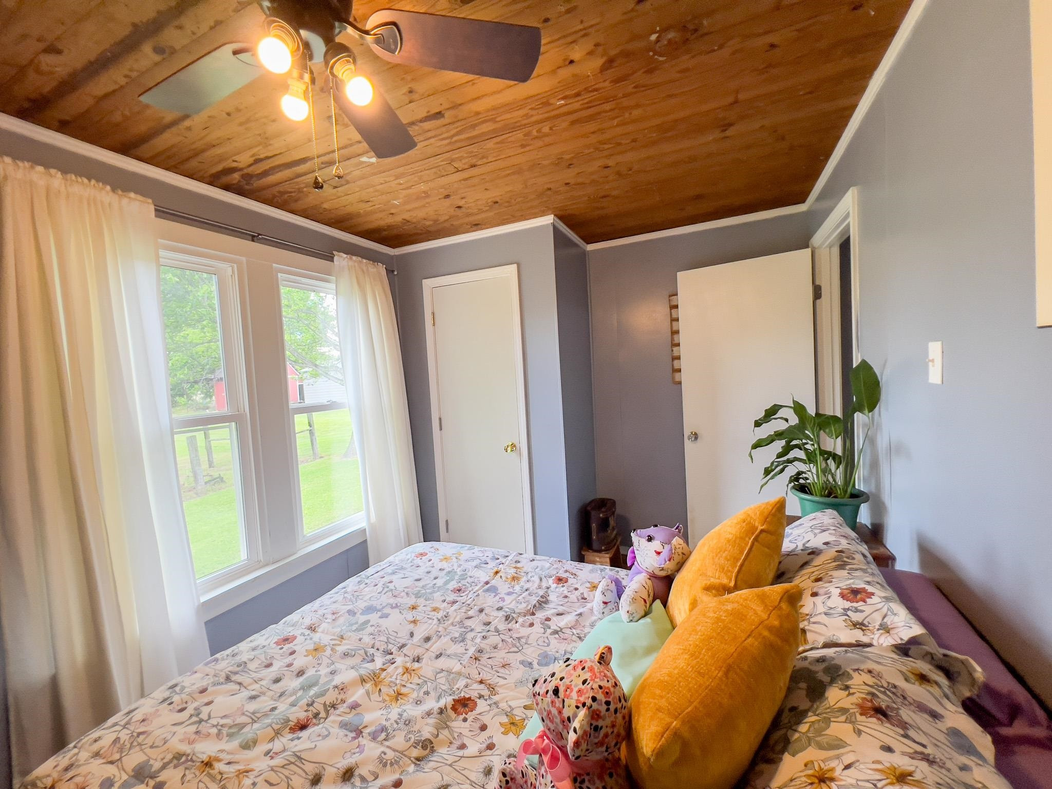 2390 Dr Lewis Road Ripley, TN 38063 - Photo 38 of 48 a bedroom with a bed and large windows