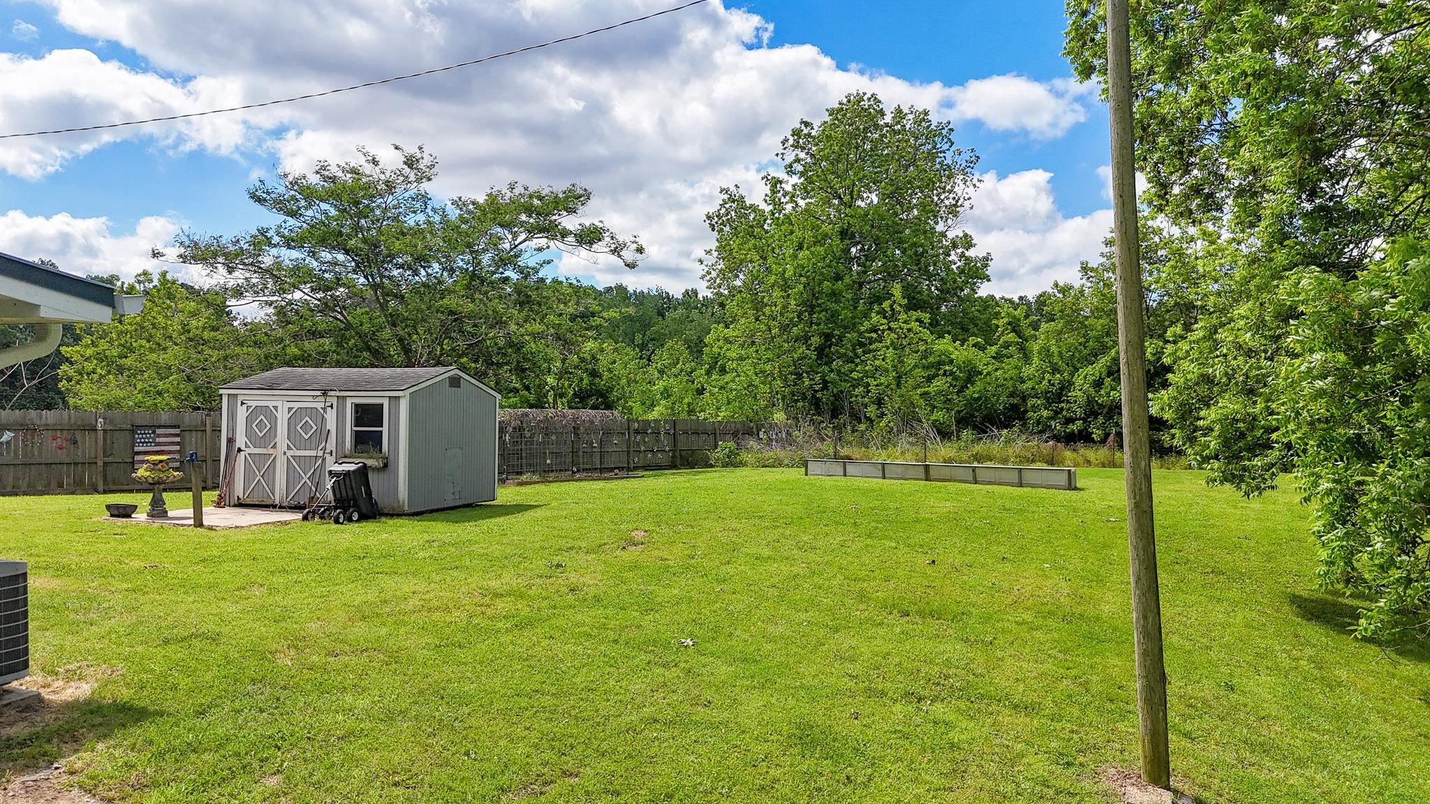 2390 Dr Lewis Road Ripley, TN 38063 - Photo 43 of 48 a house view with swimming pool in front of it